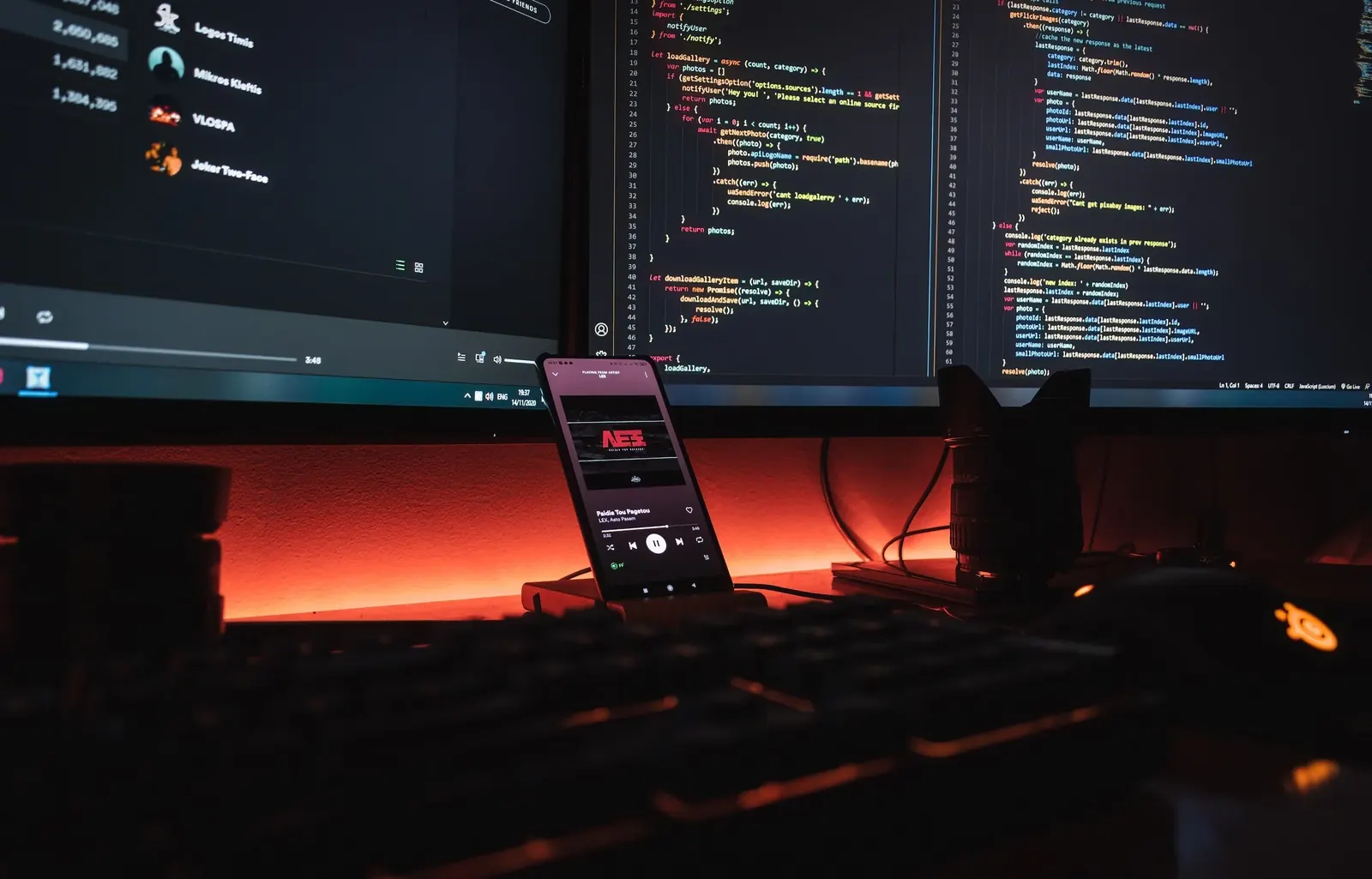 Developer desk with code on several screens